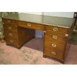 PEDESTAL DESK, campaign style mahogany and brass bound with green leather top above eight drawers,