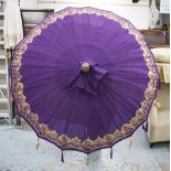 PARASOL, Indian style, in a purple and gold fabric on a part gilded pole, 260cm H.