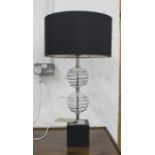 TABLE LAMP, two glass spheres with a black shade, 68cm H overall.
