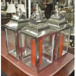 STORM LANTERNS, a set of four, of square form in plated metal frame with candles, 50cm H.