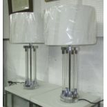 TABLE LAMPS, a pair, column type in lucite, with brass effect mounts, with shades, 68cm H.