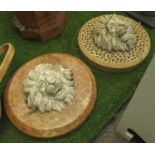 WALL PLAQUES, two, with lion masks on roundel backs, 53cm round.