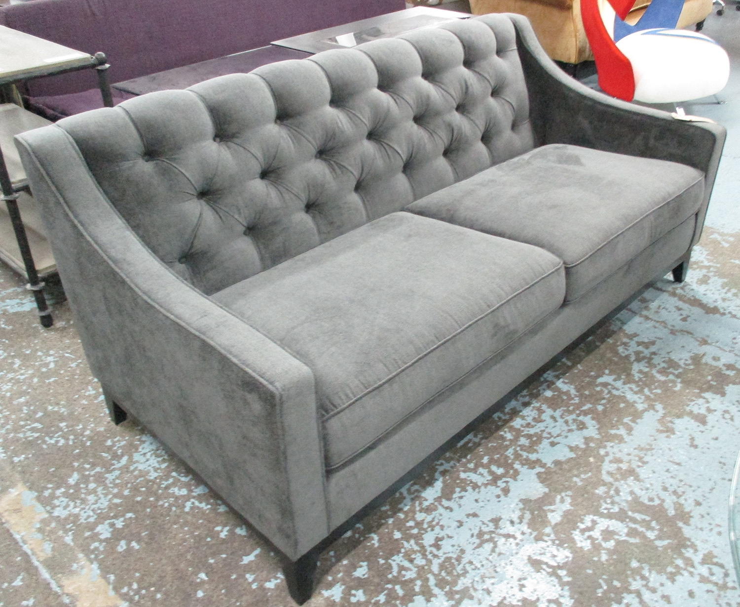 SOFA, two seater, in grey fabric, button back on ebonised square supports,