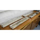 TRAYS, a set of four, in polished metal finish, 65cm x 14cm.