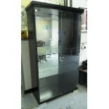 GLASS/DRINKS CABINET, with mirrored back glass shelves and glass doors within a black laquer frame,