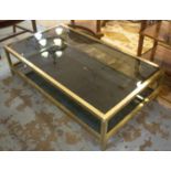 LOW TABLE, two tier, brass framed with a rectangular smoked glass top above and below, 135cm W x 35.