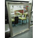 WALL MIRROR, the silver gilt frame with a bevelled plate, 115cm W x 148cm H.