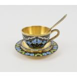 RUSSIAN SILVER GILT AND COLOURED ENAMEL CUP AND SAUCER, plus a tea spoon and small dish.