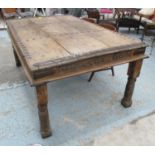 INDIAN DINING TABLE, of robust construction with a carved frieze,