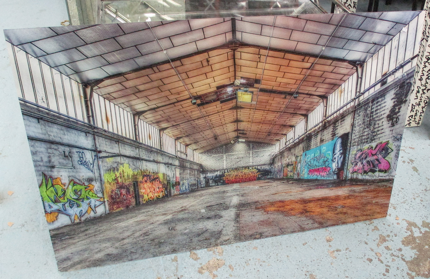 PHOTOPRINT, 21st Century, of a deserted warehouse with graffiti on acrylic, 120cm x 80cm.