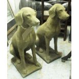 GARDEN DOG STATUES, a pair, 19th century 'Cotswold stone' style, in weathered finish,