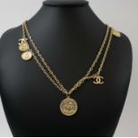 CHANEL 'COIN' NECKLACE, gold tone, plus a pair of matching earrings.