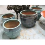 PLANTERS, a set of four, fired clay, with decorative blue glaze, two 51cm H x 63cm,