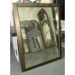 WALL MIRROR, of large proportions, gilt and black speckled frame with antique glass plate,