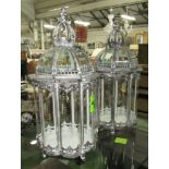 CROWN TOP STORM CANDLE LANTERNS, a pair, glass lined metal frames, hinged tops, 66cm H x 32cm Dia.