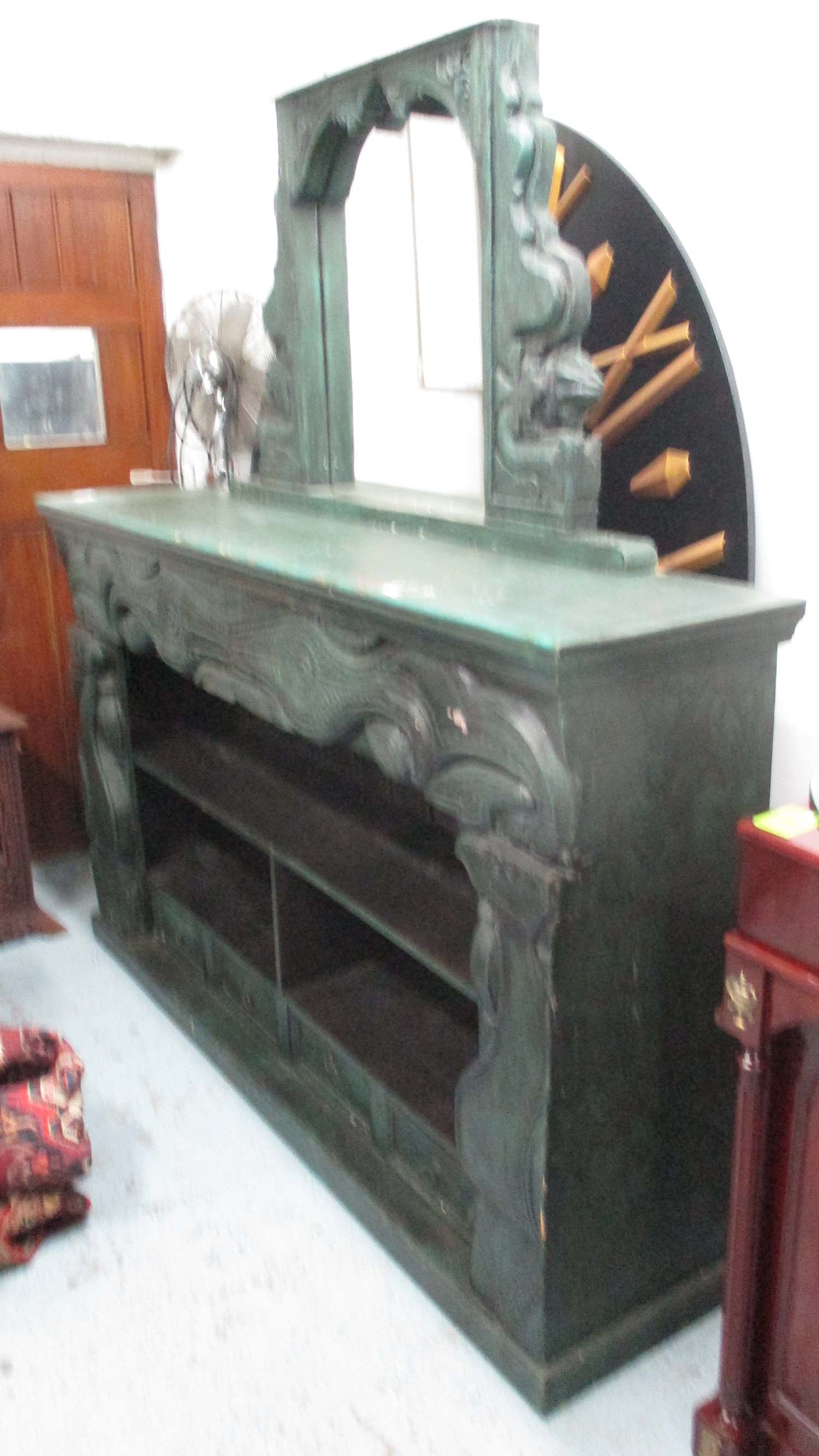 BOOKCASE, of substantial proportions, carved wood in a distressed green painted finish,