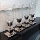 TABLE CANDLE LIGHTS, a set of four, plated silvered metal, stepped plinth bases,