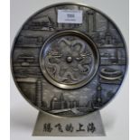 CHINESE PEWTER DECORATIVE DISH DECORATED WITH IMPERIAL DRAGONS & VARIOUS LANDMARKS ON FITTED STAND