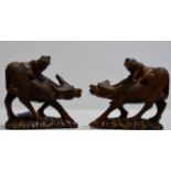 PAIR OF CHINESE CARVED WOODEN BUFFALO DISPLAYS WITH RIDERS CLAMBERING TO THEIR BACKS