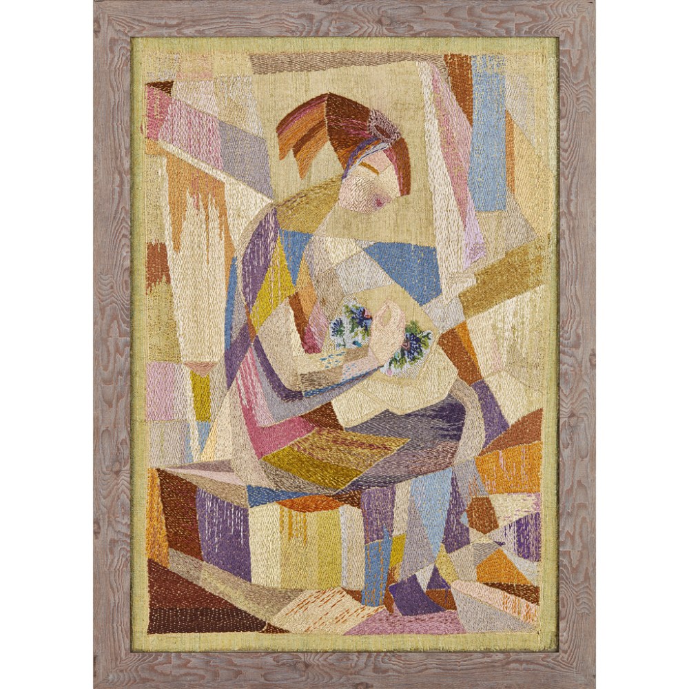 CUBIST STYLE SILKWORK PANEL, CIRCA 1920 depicting a seated figure at her embroidery, framed 64 x