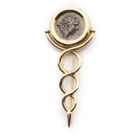 A coin set broochcollet set with a Roman coin depicting a male head in profile, above entwining