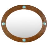 LIBERTY & CO., LONDON ARTS & CRAFTS COPPER FRAMED MIRROR, CIRCA 1910 of oval outline, the hammered