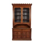 GOTHIC REVIVAL OAK BOOKCASE CABINET, CIRCA 1890 the projecting castellated cornice above two