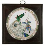 FAMILLE VERTE PORCELAIN PLAQUE KANGXI PERIOD painted with a warrior standing on the edge of a