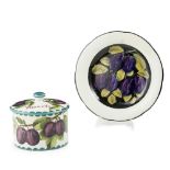 A WEMYSS WARE GORDON DESSERT PLATE AND BISCUIT BARREL & COVER 'PURPLE PLUMS' PATTERN, CIRCA 1900 the