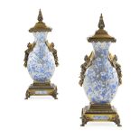 PAIR OF FRENCH GILT BRONZE MOUNTED GLAZED CERAMIC URNS 19TH CENTURY with pointed finials above