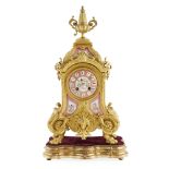 LOUIS XIV STYLE GILT METAL MOUNTED PINK PORCELAIN MANTEL CLOCK 19TH CENTURY with an urn finial above