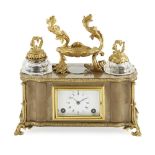 FRENCH POLISHED HARDSTONE AND GILT BRONZE DESK CLOCK LATE 19TH CENTURY the shaped top fitted with