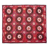 UZBEK SUZANI UZBEKISTAN, DATED 1977 the red field with allover brown and cream circular rosettes,