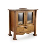 ARTS & CRAFTS OAK SMOKER'S CABINET, DATED 1918 the domed top over hinged foldaway doors, revealing