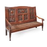 ARTS & CRAFTS OAK HALL SETTLE, CIRCA 1890 the arched back with fielded panels, each carved with