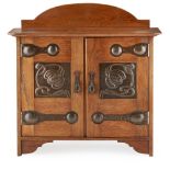 SHAPLAND & PETTER, BARNSTAPLE ARTS & CRAFTS OAK WALL CABINET, CIRCA 1900 the projecting moulded