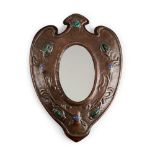 ARTS & CRAFTS COPPER WALL MIRROR, CIRCA 1900 the oval plate enclosed by shield-shaped frame