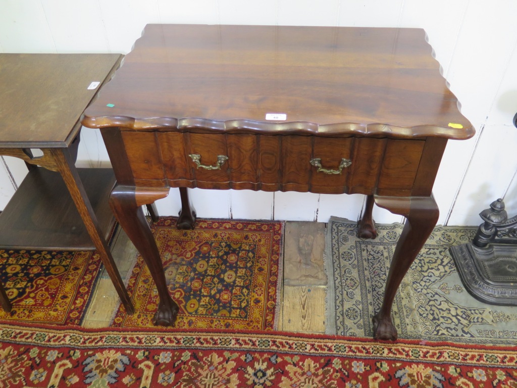 A Dutch style walnut side table, the shaped edge top over a moulded drawer on cabriole legs with