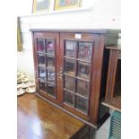 An Edwardian walnut wall unit, with two bevelled glass panel doors, 62cm wide, 55cm high