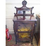 A late Victorian carved wood display cabinet, the raised mirror panelled back over cabriole supports