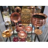 Copper wares including a jardiniere, two bowls with three-ball feet, globular vase, brass letter