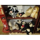 A variety of plush panda bears and other soft animal toys