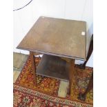 An Arts and Crafts style oak side table, the square top over a pierced frieze on square tapeing legs