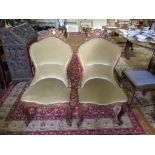 A pair of late 19th century French rosewood side chairs, the upholstered spoon backs with carved