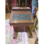 An Edwardian walnut Davenport, with foliate carved panels, the hinged top section with fitted