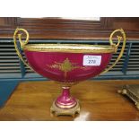 A Sevres style and giltmetal mounted boat shape vase, the crimson ground with panel depicting a