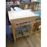 An ash food preparation trolley with cutlery drawer and wine basket, 67cm wide