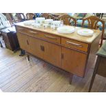 A G-Plan teak dining room suite comprising sideboard, pedestal dining table and six chairs including
