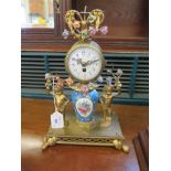 A late 19th century French ormolu and porcelain mounted timepiece, the A. Marchandon single train