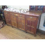 An Edwardian oak sideboard, with three frieze drawers over four panelled doors on turned legs, 181cm